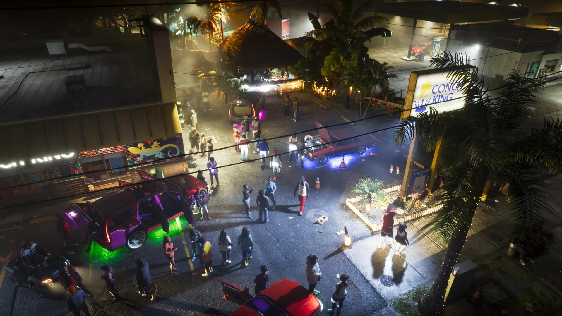 Escena nocturna con personas y coches modificados en un aparcamiento, capturada del tráiler de Grand Theft Auto 6.